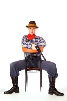Resolute cowgirl with gun sitting on the chair (isolated on white)