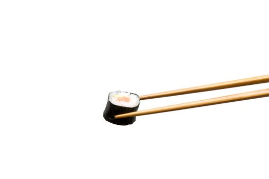 Two chopsticks with roll (isolated on white)