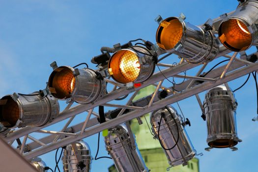 Stage light beam with 9 lights against a blue sky