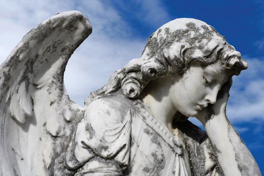 Statue of an sad angel.  Sculpture was on top of a gravestone from the 1800's.
