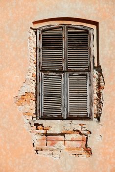 Old vintage unattained house window on ruined facade