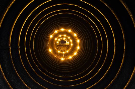 Inside of a pipe illuminated by electric lamps