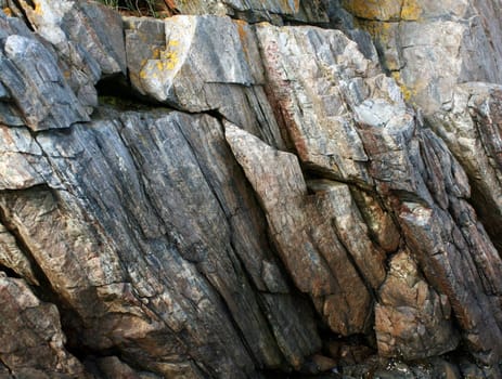 Granite cliffs in Maine, showing striations of gray