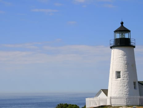 a horizontal view of Pemaquid Point Lighthouse in Maine, showing the ocean in the background