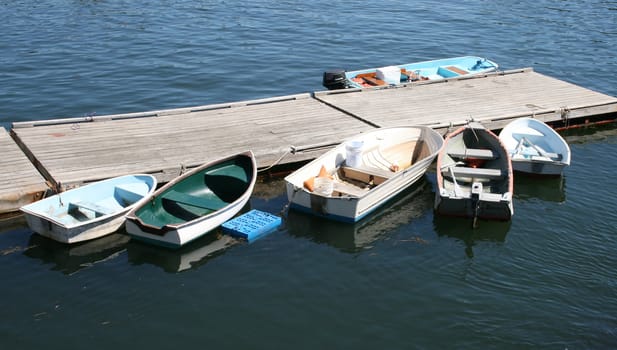 six skiffs, tied up at dock