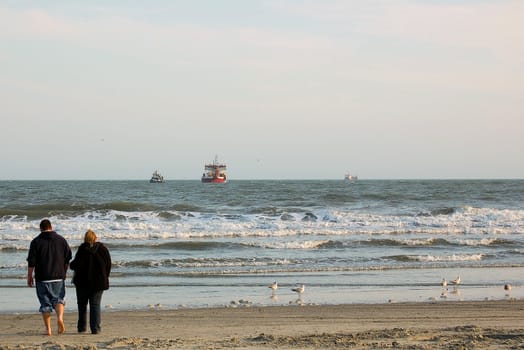 Couple walks together on the beach