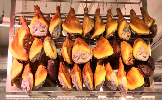 A lot of dried smoked, hams in grocery store
