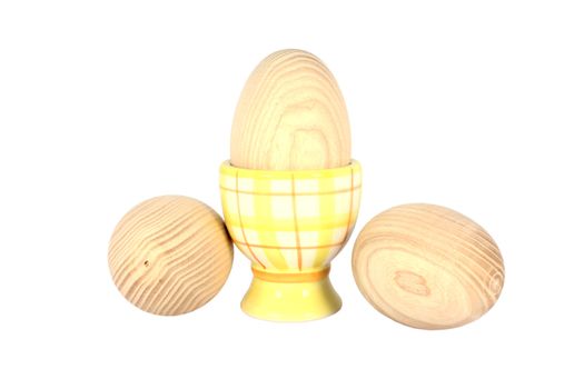 Wooden egg on the pedestal with two beside, isolated on white