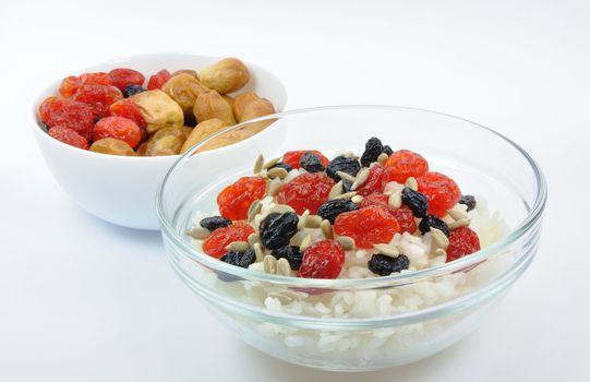 Two Bowls with Boiled Rice and Dried Fruit on White Background