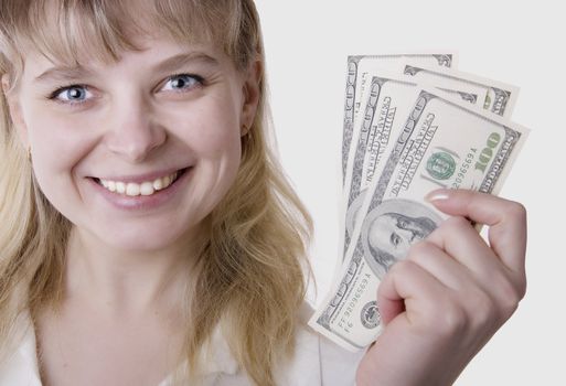 Beautiful businesswoman holding Dollar notes isolated on white 
