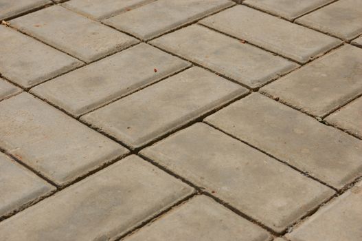 close-up of new pavement of stoneblocks (bricks) of grey color