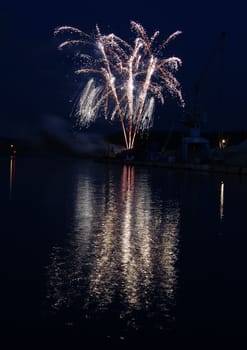 Display of fireworks with a water reflection