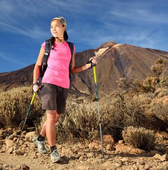 Female hiker. Young mixed chinese / caucasian female model hiking / backpacking in beautiful volcanic landscape on the volcano, Teide, Tenerife, Spain. 