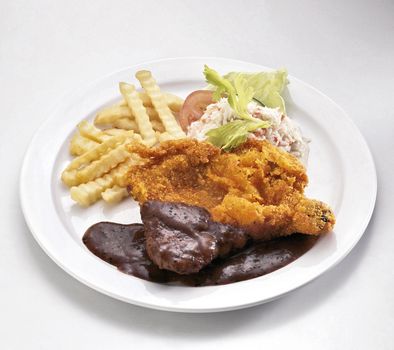 chicken chop with french fries and salad