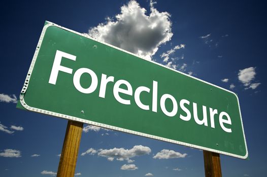Foreclosure Road Sign with dramatic clouds and sky.