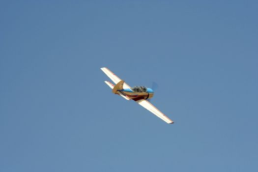 Propeller-driven airplane on clear sky  background 