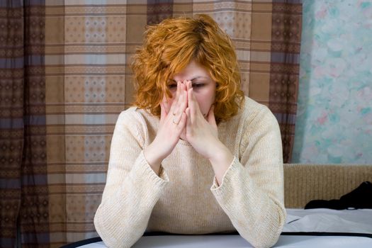 Young stressed woman sitting on the bed