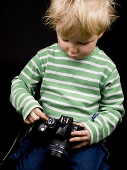 Little boy on black background. Boy have  blond hair