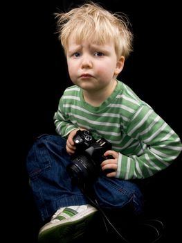 Little boy on black background. Boy have blue eyes and blond hair