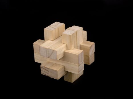 Wooden puzzle on black background