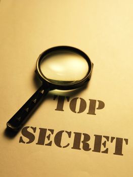 magnifying glass on the text of secret