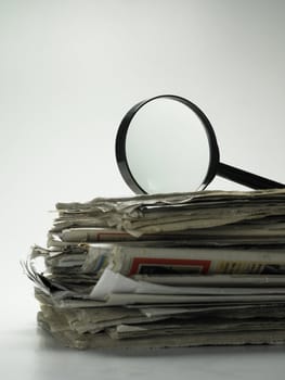 magnifying glass on top of newspaper
