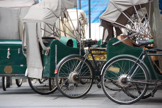 Trishaws parked on a street