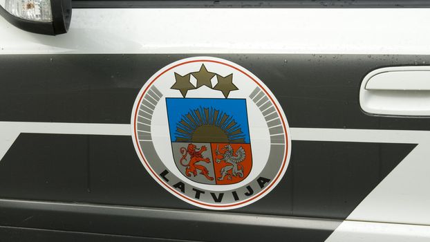 Latvian police car`s door with coat of arms.