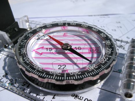 Compass and blueprints. Focus on arrow.