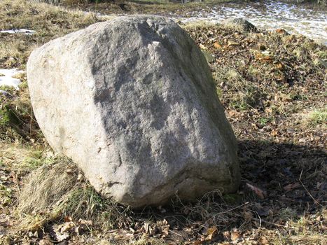 A huge stone in a park.