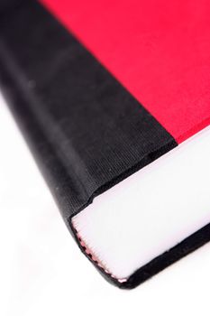Closeup of a red and black book isolated on a white background