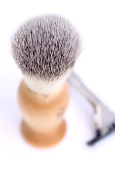 Old style brush and razor on white background.