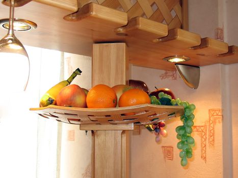 Kitchen wooden shelf with fruits