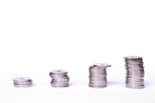 Stacks of coins on white background. Norwegian coins used in the picture.