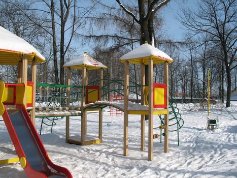 Child playground on winter sunny day.