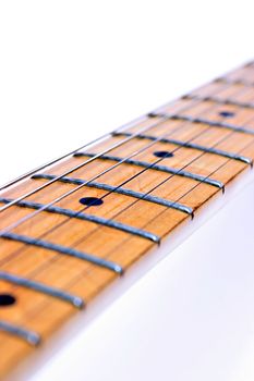 Closeup of a guitar fretboard on white background
