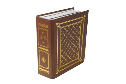 The brown photo album with 	gold lettering on white background. Close-up.