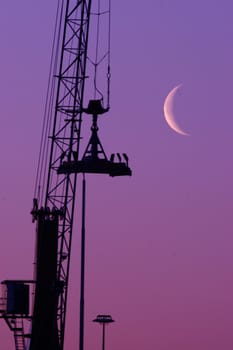 Shipyard crane against the moonlight - with plenty of copy space