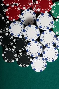Big stack of poker chips on felt table
