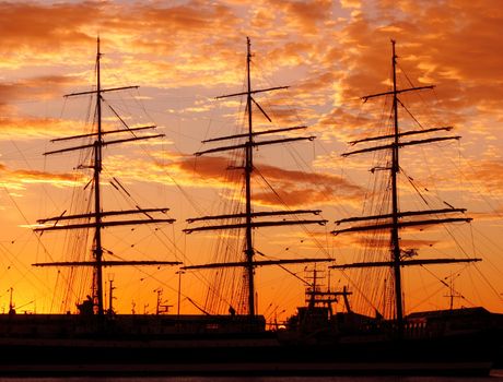 Silhouette of a schooner against the sunset