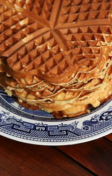 Delicious traditional waffles stacked up on a antique plate