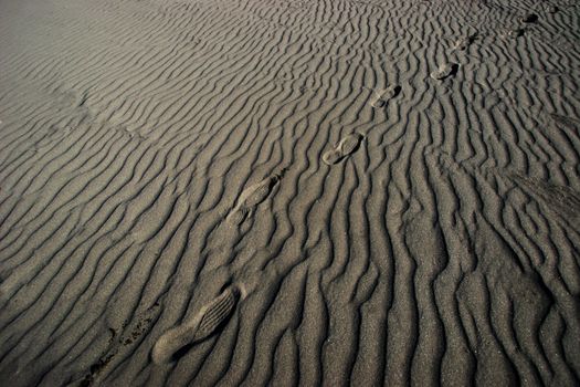 Footprints in sandy beach texture