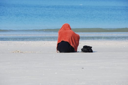 A person meditation on a tropical beach
