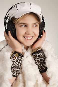 Adorable young female enjoying music on her headphones.
