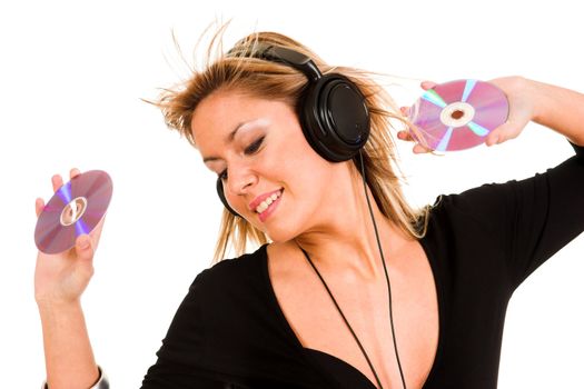 beautiful young woman listening music in headphones and holding two CD 