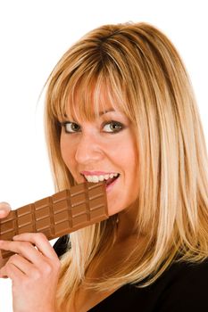 young girl eating chocolate on white background