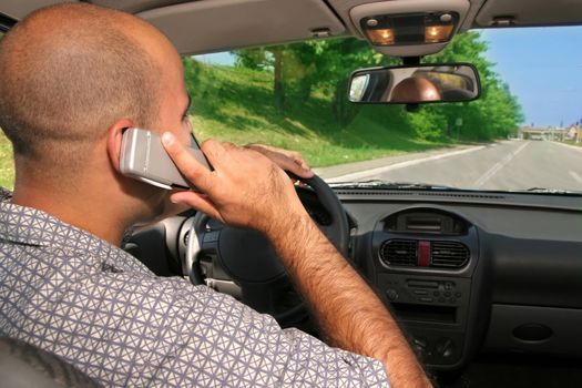 Young adult hold mobil phone during driving