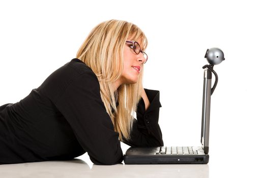 A businesswoman using laptop and webcam