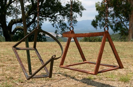 broken child's swing chair on a park
