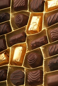 Close-up photo of christmas chocolate in gold packing